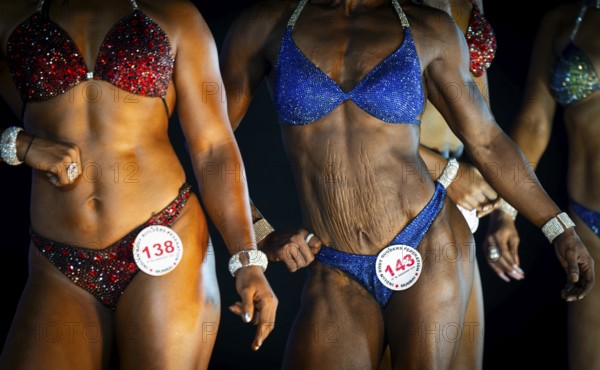 Female bodybuilders pose on stage as they compete the 4th Ms Saraighat all India classic body building championship on March 23, 2025 in Guwahati, India, Asia