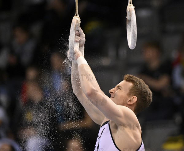 Nils Dunkel GER prepares rings with magnesia Gymnastics, EnBW DTB-Pokal, Porsche-Arena, Stuttgart, Baden-Württemberg, Germany, Europe