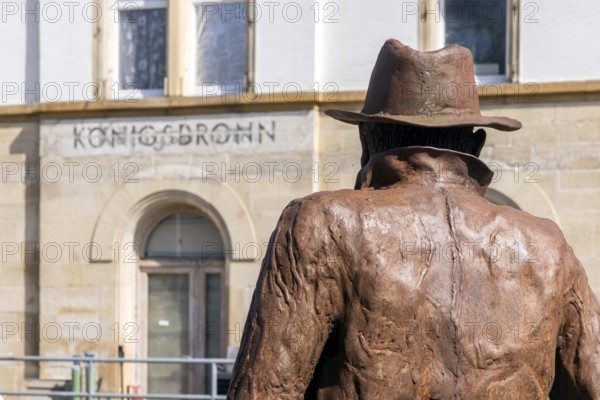 Georg Elser memorial at Königsbronn railway station. The statue by Friedrich Frankowitsch shows the resistance fighter Elser ready to travel with sticks of dynamite in his suitcase, waiting for a train on the Brenzbahn towards Munich. Königsbronn, Baden-Württemberg, Germany, Europe