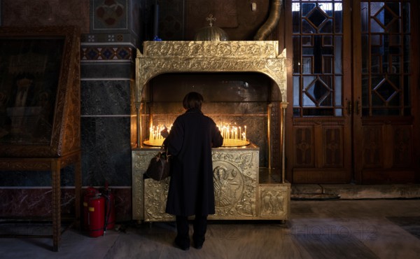 Woman offering a candle, from behind, interior view of Hagia Sofia church, also Agia Sofia, dome, Thessaloniki, Macedonia, Greece, Europe