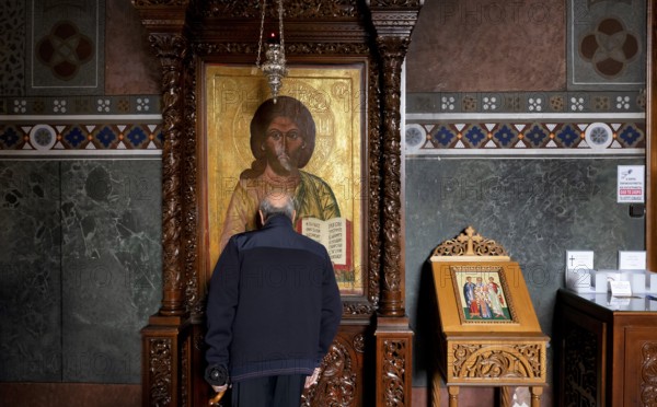 Elderly man praying in front of an image of a saint, from behind, interior view of Hagia Sofia church, also Agia Sofia, dome, Thessaloniki, Macedonia, Greece, Europe