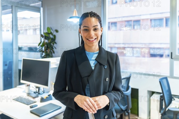 Portrait of a businesswoman smiling in a modern office, showcasing confidence and professionalism in the workplace