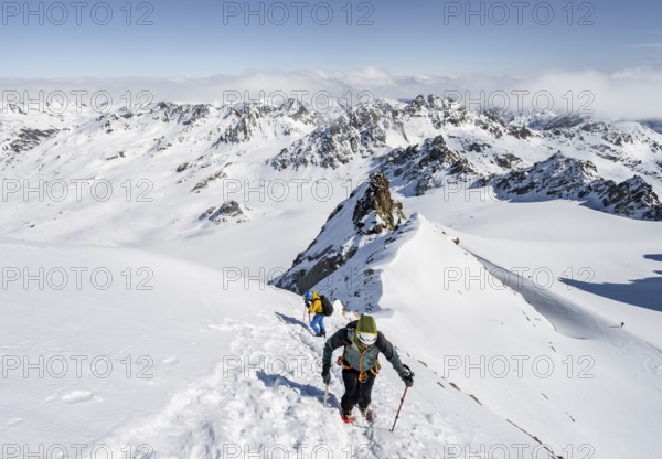 For mountaineers with ice axe and crampons, ascent through steep snowfield to Piz Kesch or Piz d'Es-cha in winter, view of mountain panorama with Vadret da Porchabella glacier, Albula Alps, Rhaetian Alps, Grisons, Eastern Switzerland, Switzerland, Europe