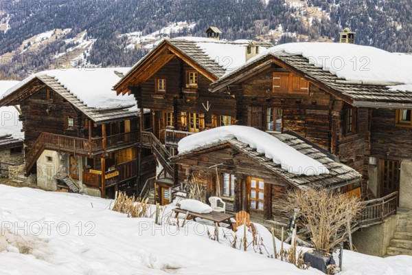 Old wooden houses with snow-covered roofs in the historic village centre, Grimentz, Val d'Anniviers, Valais Alps, Canton Valais, Switzerland, Europe