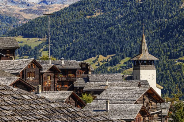 Old wooden houses and the Saint Theodule church in the historic village centre, Grimentz, Val d'Anniviers, Valais Alps, Canton Valais, Switzerland, Europe