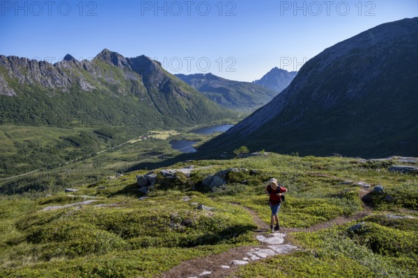 Mountaineers on a hiking trail to the summit of Rundfjellet, mountain landscape and valley with lakes, near Austnesfjord, Svolvaer, Nordland, Norway, Europe