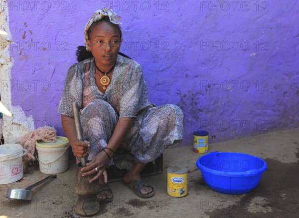 In the highlands of Abyssinia, in the village of Sina, young woman prepares coffee for the coffee ceremony, Ethiopia, Africa