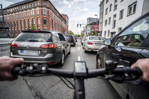 Cycling in the city, city centre road, no cycle lane, two-lane traffic in both directions, cyclists' perspective, Essen, North Rhine-Westphalia, Germany, Europe