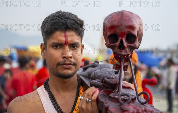 A Hindu priest arrives awith a human skull on the bank of Brahmaputra river on Ashoka Ashtami Festival during Chaitra Navratri on April 5, 2025 in Guwahati, India, Asia
