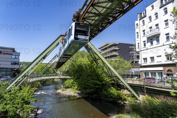 The Wuppertal suspension railway, train of the latest generation 15, floats above the Wupper, North Rhine-Westphalia, Germany, Europe