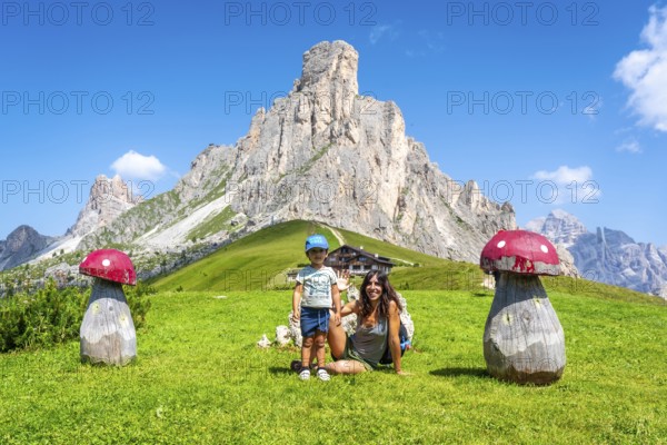 Mother and son enjoying a summer vacation in the stunning italian dolomites, surrounded by the breathtaking scenery of giau pass