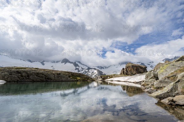 Mountains and glaciers reflected in the Schwarzsee lake, Schwarzensteinkees and Hornkees glaciers, Schwarzenstein and Hornspitzen peaks, Berliner Höhenweg, Zillertal Alps, Tyrol, Austria, Europe