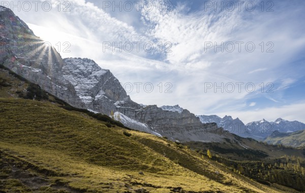 Mountain landscape with yellow meadows in autumn, summit Lamsenspitze with sun star, Karwendel, Tyrol, Austria, Europe