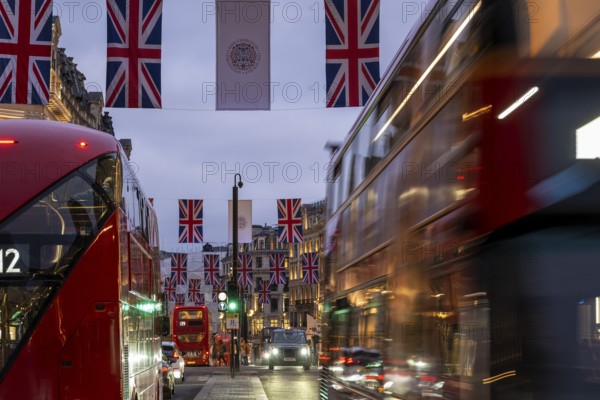 Red double-decker buses, English flags, evening mood, Oxford Circus, London, London region, England, Great Britain