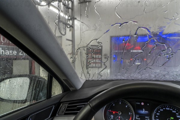 Car in an automatic car wash, car wash tunnel