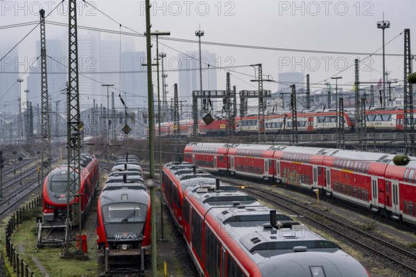 Railway tracks with regional trains, after freezing rain, in front of Frankfurt main station, skyline in the fog, Hesse, Germany, Europe