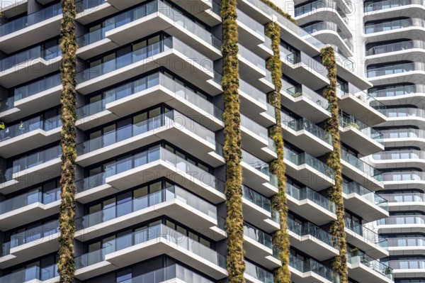 Facade of the Eden Tower on Europa-Allee in Frankfurt am Main, green facade, residential building, apartment building, on the right the Grand Tower building, flats, Hesse, Germany, Europe