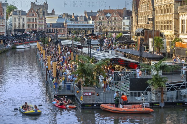Visitors on grandstand at the Graslei watching Pole Pole podium during Gentse Feesten, Ghent city festival, summer festivities in Flanders, Belgium, Europe