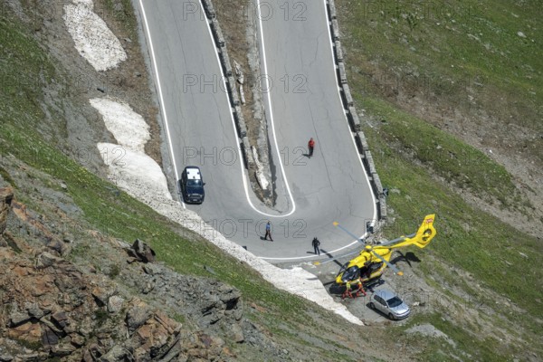 Stilfserjoch, Vinchgau, South Tyrol, Italy, Stilfser Joch pass road, the ascent over the tight bends, the narrow hairpin bends is a popular destination for cyclists, motorcyclists and motorists. Emergency doctors from a rescue helicopter on their way to a cyclist who has had an accident, Europe