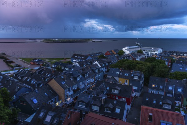 View from the upper land over the houses in the lower land to the Helgoland dune, Helgoland island, evening light, cloudy sky, North Sea, Pinneberg district, Schleswig-Holstein, Germany, Europe
