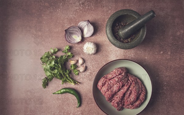 Fresh minced meat, raw, with spices and ingredients. on the table, preparation, top view