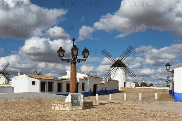 Street lamp and windmill in a picturesque village with white houses and cobbled streets, windmills and village, Campo de Criptana, Ciudad Real province, Castilla-La Mancha, Route of Don Quixote, Spain, Europe
