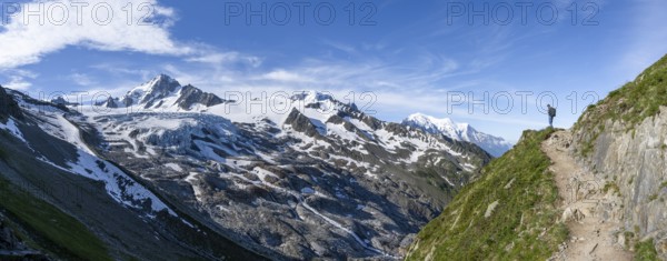 Mountaineer on a hiking trail, view of high alpine mountain landscape, summit of Aiguille de Chardonnet and Glacier du Tour, glacier and mountain peak, Chamonix, Haute-Savoie, France, Europe