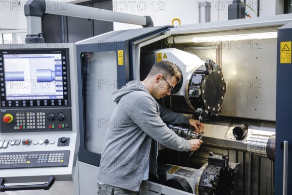 Remscheid, North Rhine-Westphalia, Germany - Trainee in metalworking, here at a CNC machine tool, Vocational Training Centre of the Remscheid metal and electrical industry. - FOR EDITORIAL USE ONLY!