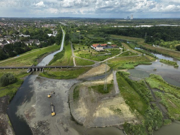 Dortmund / Castrop-Rauxel, North Rhine-Westphalia, Germany, river renaturalisation, renaturation of the Emscher, flood retention basin HRB Mengede. A new floodplain landscape is being created at the Emscher-Auen farm, expanding the area for flood protection during heavy rainfall and for biodiversity. The Emscher, which is currently straightened, will be given curves again and can meander through its new floodplain. Following the construction of a parallel sewer, the Emscher has been completely free of wastewater since 2022. The river was previously an open, above-ground mixed water channel with rainwater and wastewater. At the back right, the Uniper coal-fired power plant Datteln 4 power station, Europe