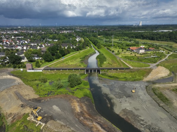 Dortmund / Castrop-Rauxel, North Rhine-Westphalia, Germany, river renaturalisation, renaturation of the Emscher, flood retention basin HRB Mengede. A new floodplain landscape is being created at the Emscher-Auen farm, expanding the area for flood protection during heavy rainfall and for biodiversity. The Emscher, which is currently straightened, will be given curves again and can meander through its new floodplain. Following the construction of a parallel sewer, the Emscher has been completely free of wastewater since 2022. The river was previously an open, above-ground mixed water channel with rainwater and wastewater. At the back right, the Uniper coal-fired power plant Datteln 4 power station, Europe