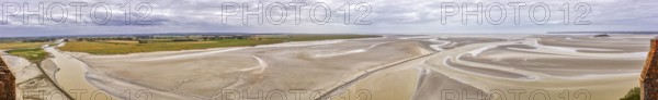 Expansive panorama with sand, watercourses and a wide horizon under a cloudy sky, Le Mont-Saint-Michel