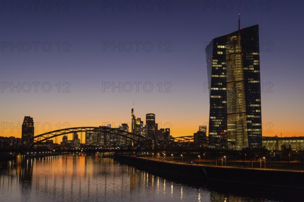 The lights in the offices of the European Central Bank (ECB) and the Frankfurt skyline glow in the evening after sunset, Osthafen, Frankfurt am Main, Hesse, Germany, Europe