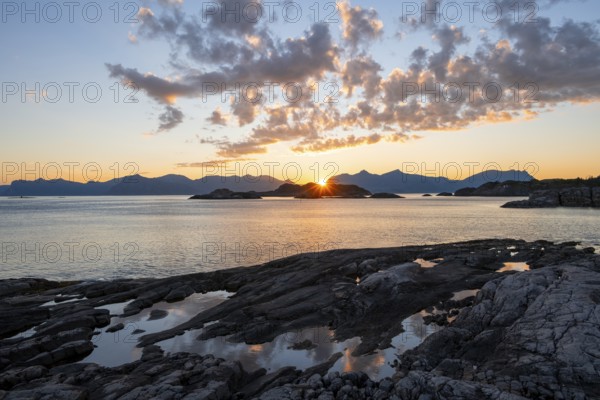 Clouds reflected in a small pond on a rocky coast, coastal landscape at sunset, Henningsvær, Lofoten, Nordland, Norway, Europe