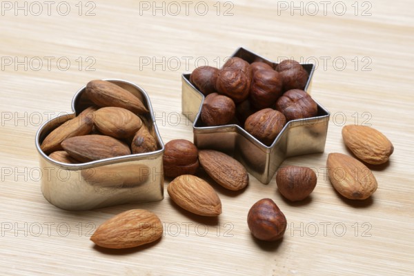 Nuts and cookie cutters, almonds and hazelnuts