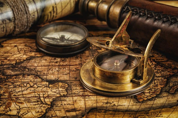 Travel geography navigation concept background, old vintage retro compass with sundial, spyglass and rope on ancient world map