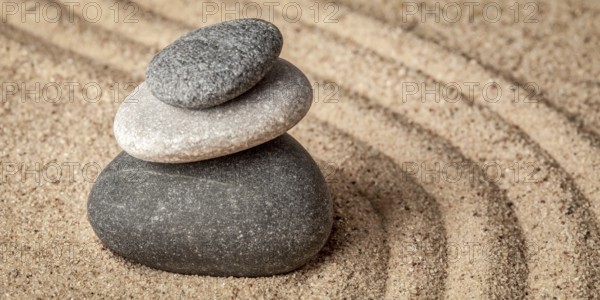 Japanese Zen stone garden, relaxation, meditation, simplicity and balance concept, letterbox panorama of pebbles and raked sand tranquil calm scene