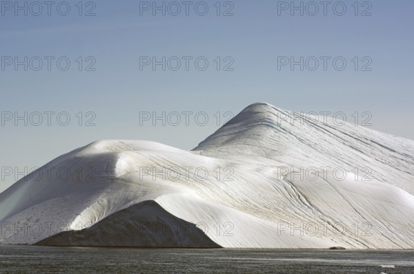 Giant iceberg in the glow of the midnight sun Disko Bay, Ilulissat, Arctic, Greenland, Denmark, North America