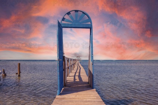 A blue door in the Caribbean Sea on the island of Roatan at sunset. Honduras