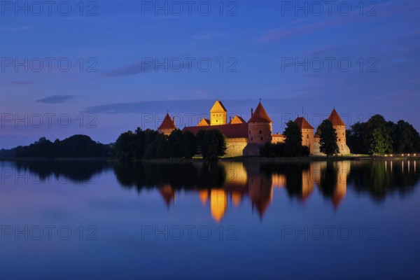 Evening view of Trakai Island Castle in lake Galve illuminated in the night, Lithuania, Europe