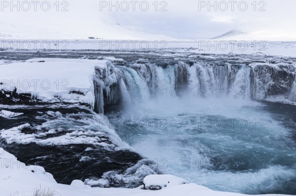 Godafoss waterfall, icy and snowy rock face, snowy landscape, Northern Iceland Eyestra, Iceland, Europe