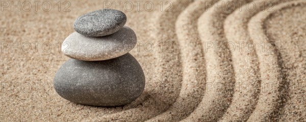 Japanese Zen stone garden, relaxation, meditation, simplicity and balance concept, letterbox panorama of pebbles and raked sand tranquil calm scene
