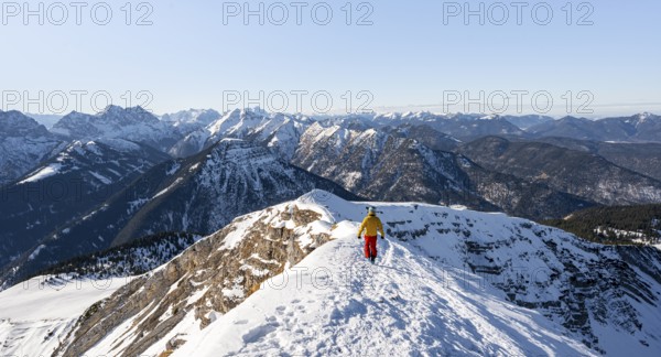 Ski tourers at the summit of Schafreuter, view of snow-covered mountain panorama, Karwendel, Tyrol, Austria, Europe