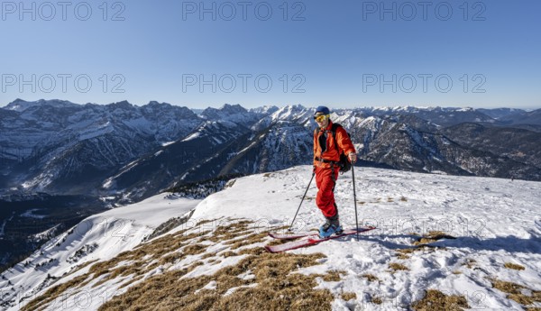 Ski tourers at the summit of Schafreuter, view of snowy mountain panorama, Karwendel, Tyrol, Austria, Europe