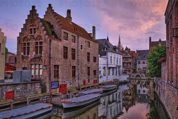 Bruges Rozenhoedkaai old houses along canal with tree in the evening. Famous place of Brugge, Belgium, Europe