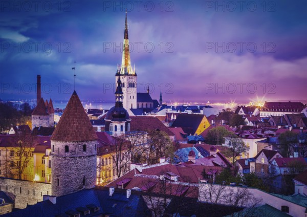 Vintage retro effect filtered hipster style image of Tallinn Medieval Old Town illuminated in evening twilight, with dramatic sky Estonia