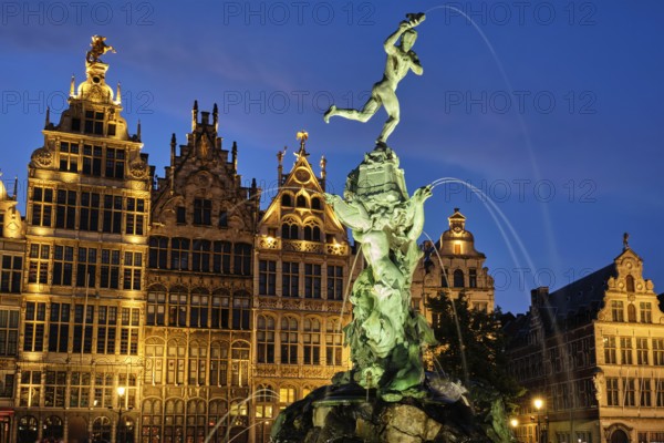 Antwerp famous Brabo statue and fountain on Grote Markt square illuminated at night and old houses. Antwerp, Belgium, Europe