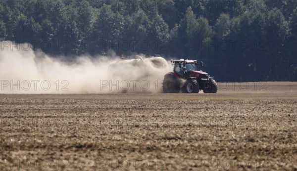 Upper Lusatia, Saxony, Germany - Dust-dry fields in a hot summer, a tractor working the field, spreading liquid manure directly into the soil