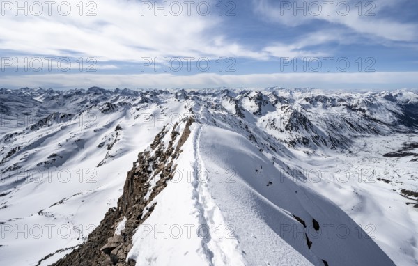 Tracks in the snow on a narrow mountain ridge in winter, summit of Piz Grialetsch, view of mountain panorama with snow, Grisons Haute Route, Albula Alps, Rhaetian Alps, Grisons, Switzerland, Europe