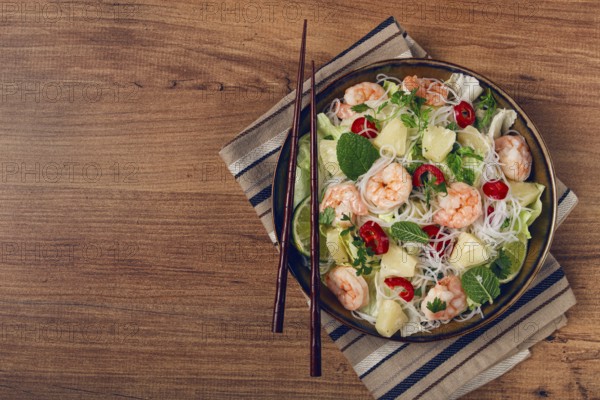 Thai salad with shrimp and rice noodles, pineapple slices, coriander and mint leaves, homemade, no people