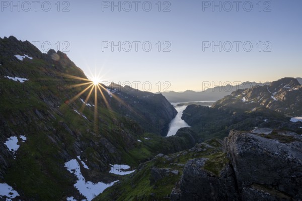 Picturesque mountain landscape at sunrise with sun star, fjord Trollfjord and Raftsund, hike to Trollfjord Hytta, Lofoten, Nordland, Norway, Europe